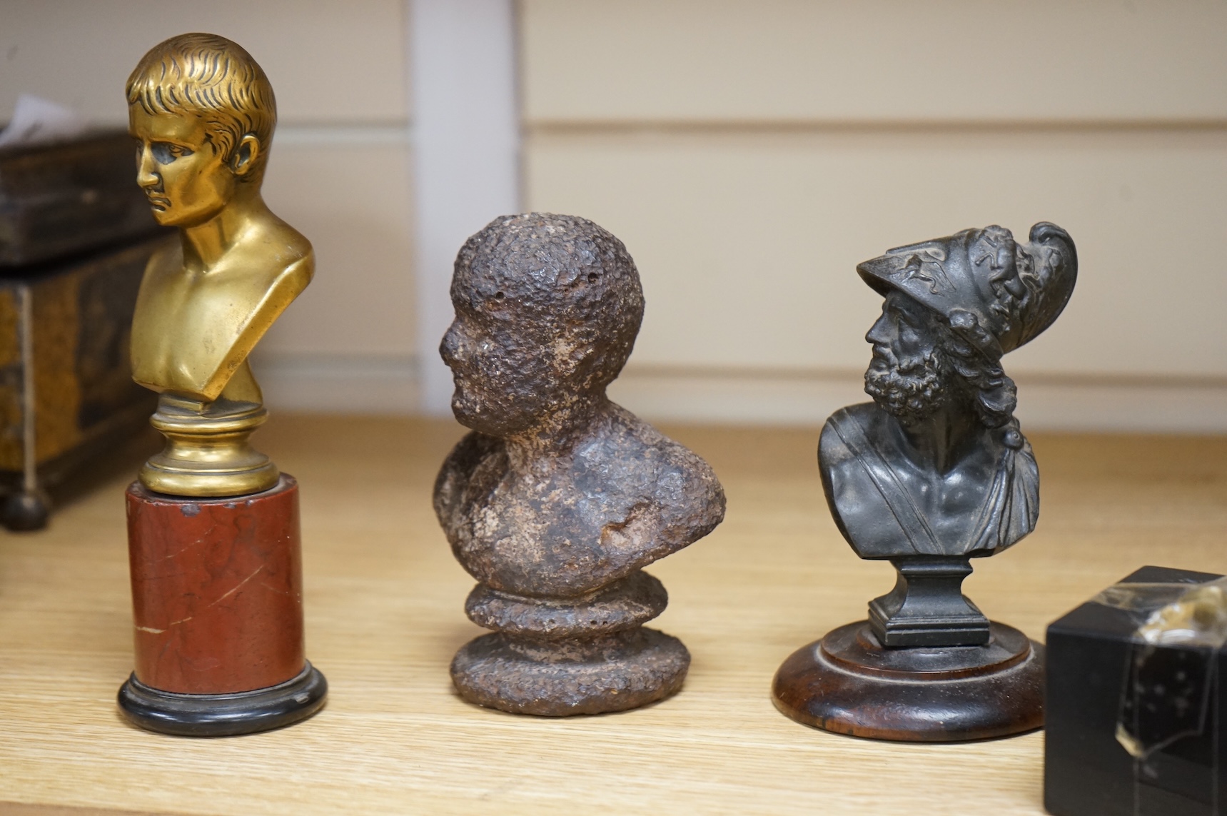 A bronze bust of Napoleon, a bust of Ajax and a cast iron bust of an Emperor, tallest 18cm